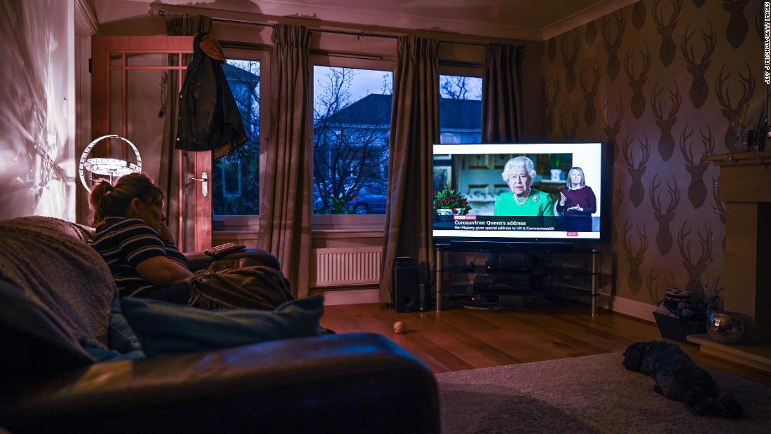 A woman in Glasgow, Scotland, watches Britain&#39;s Queen Elizabeth II &lt;a href=&quot;https://www.cnn.com/2020/04/05/uk/queen-elizabeth-ii-coronavirus-address-gbr-intl/index.html&quot; target=&quot;_blank&quot;&gt;give a television address&lt;/a&gt; regarding the coronavirus pandemic.